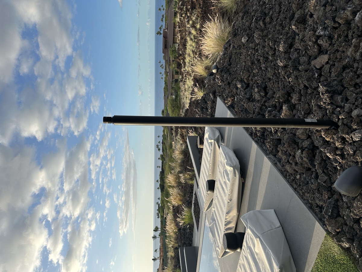 KAZ automated gas tiki torch standing in tropical landscape — Kailua Kona, Hawaii